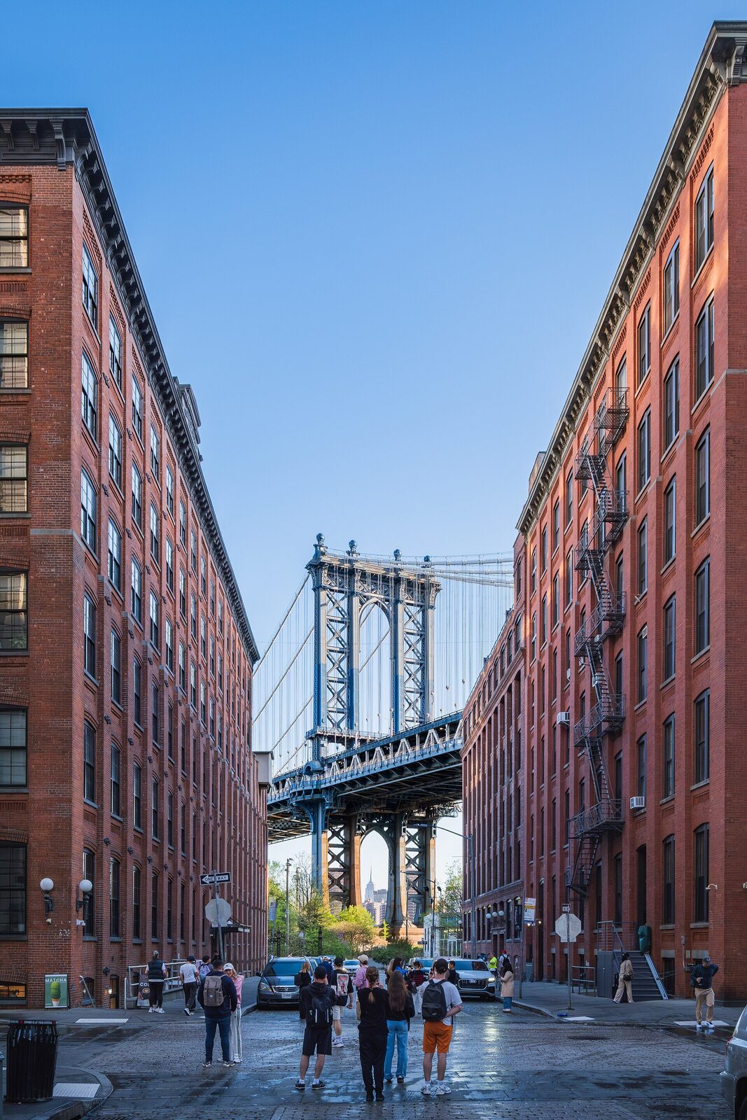 Pedestrians crossing the Brooklyn Bridge toward Manhattan